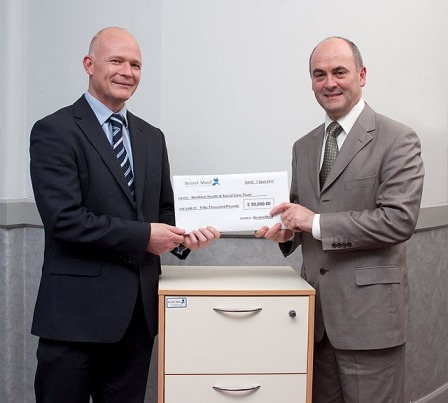 Mr Sean Donaghy (right), Chief Executive of the Northern Health and Social Care Trust, receiving a cheque for £50,000 from Mr Ian Farnfield (left), Sales Director of Hospital Metalcraft Ltd